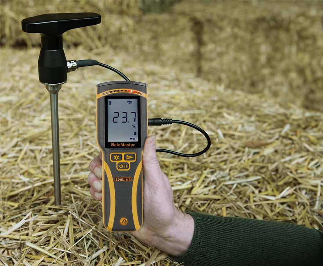 Protimeter Balemaster bale moisture meter and probe inserted in straw bale