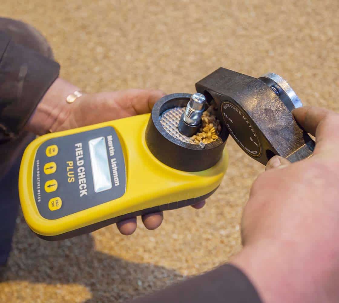 Loading grain into the field check plus moisture meter
